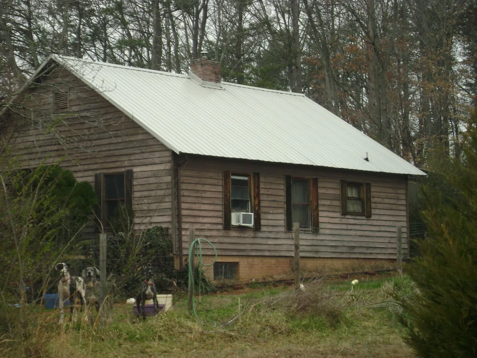 White metal roof on an old wood sided farmhouse, from a Metal Roof Installation job in Rockaway Park